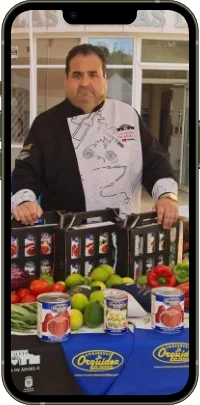 Chef Ángel G with La Orquídea preserves, on a phone screen